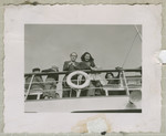 Immigrants to the United States stand on the deck of the Marine Flasher.