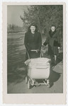 Anna Rosenzweig pushes a baby carriage in the Bergen-Belsen displaced persons camp.