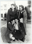 Four female members of the Gordonia Zionist youth movement pose together on a street in Brussels.