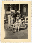 Four Jewish youth relax outside a building in La Ramee agricultural school.