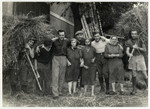 Group portrait of Jewish workers with civilian seasonal employees at the Lipa farm, labor camp.