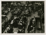 One of the defendants of the Krupp Case stands in the defendants dock while American military police stand behind him.