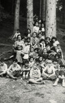 Children from the OSE Home de la Foret children's vacation colony pose in the woods.
