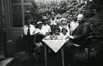 Chana and Mordechai Emanuel stand with their children by a table outside their home.