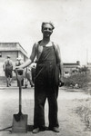 Kurt Markus poses with his shovel in the Pingliang roand Refugee Camp in Shanghai, China.