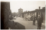 Survivors and American servicemen stand on a main artery of the Gusen concentration camp following liberation.