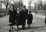 Ewa Kracowska walks down a street in Bialystok with her uncle, his fiancee and her brother.
