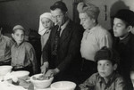 Yehoshua Birnbaum prepares a meal in a home in Maastricht where the family was staying together with the orphans under their care.