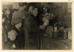 A woman and her child collect their rations at a food distribution center in the Lodz ghetto.