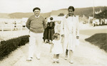 Irene Lewitt walks down the beach with her parents.