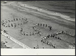 Children spell out the word "OSE" on the beach in Saint Quay.