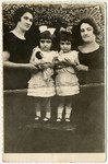 Studio portrait of the four Herskovic sisters.

From left to right are Emilia, Helen, Pearl and Miriam.