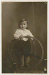 Studio portrait of a young Jewish child identified as Hinda's son.