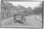 US Army officers from the 91st Evacuation Hospital Unit drive through a German town.