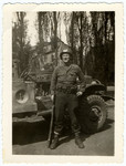 Lloyd Rissinger, a lliberator of the Ohrdruf concentration camp, poses next to his jeep.