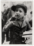 Original Caption: "A Russian youngster eats hungrily of bread and molasses.