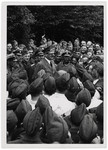 Adolf Hitler meets with a large group of soldiers.