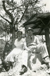 Saul and Erna rest on a large rock while visiting Baguio.