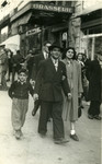 Shimon Sousson, his wife, and their son walk down a commerical street of Marseilles.
