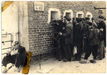 Residents of the Lodz ghetto wait outside the kitchen #452 to receive their food rations.