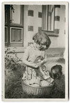 Hedwig de Levie sits in a basket and plays with a kitten near her home in Oldenburg.