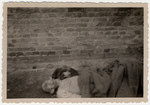 The body of a prisoner lies outside of a barrack in Woebbelin.