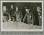 Adolf Hitler reviews military plans with his High Command.