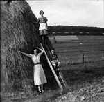 Rosa Lewinnek poses with her two children, Anne Laure and Arieh, next to a large haystack in a farm in Belgium.