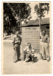 David Bayer and two friends pose next to a sign at an army base in Israel where they were stationed during the War of Independence.