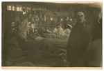 Survivors rest on cots in a makeshift hospital shortly after the liberation of Dachau.