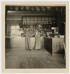 Two men pose by the bar in the Bergen-Belsen displaced persons camp.