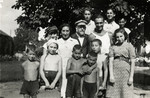 Janusz Korczak (center) and Sabina Lejzerowicz (to his right) pose with children and younger staff members in his orphanage.