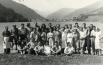 Group portrait of Jewish DPs posing next to a lake in Davos with nurses and doctors.