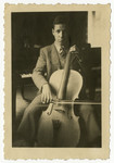 Norbert Mueller practices cello in his home in Nuremberg