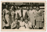 Cantor Moses Rontal poses with female displaced persons [probably in Stuttgart].