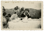 Sebald Mueller sits at a table with an unidentified family friend while vacationing in the mountains.