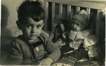 Villiam Krausz (Benjamin Kedar )sits surrounded by his toys shortly before the family went into hiding.