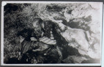 Two corpses lie on the ground of the Klooga camp following liberation.