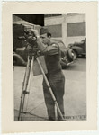 Portrait of American Jewish signal corps photographer Paul Enfield with his movie camera.