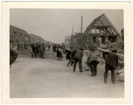 German civilians clear rubble from the Nordhausen camp to make room for corpses that were to be piled there.