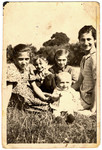Members of the Slomnicki family pose together on the grass.