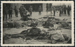 American soldiers take photographs of corpses lying on the ground of the newly liberated Ohrdruf concentration camp.