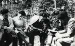 A group of five persons studies outdoors. 

Pictured in the center is Noemi Cassuto, aged 3 or 4.