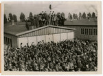 View of Dachau concentration camp prisoners cheering on their liberators.