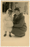 Mania and Frieda Kerschenblat pose on a snowy street of the Schlachtensee displaced persons camp.