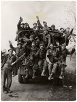 Recently liberated American POWs wave as they leave their camp.