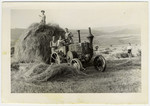 DPs use a tractor to move a huge stack of hay at a hachshara in the Eschwege displaced persons' camp.