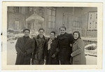 A group of young DPs gather outside in the snow at the Eschwege displaced persons' camp.
