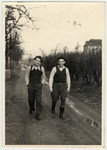 Willy Bogler and a friend walk down a road at the Eschwege displaced persons' camp.