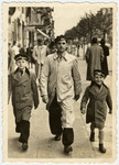 Three Jewish brothers walk down a street in Sofia en route to a concert.